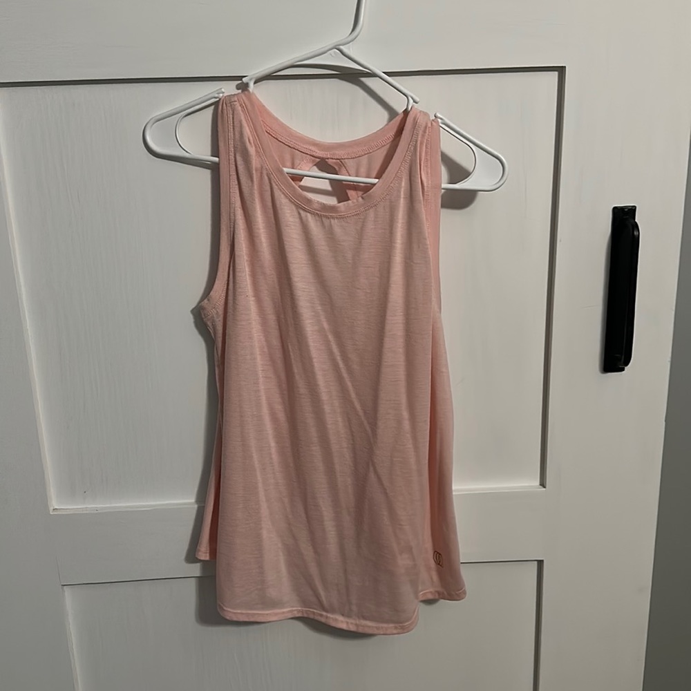 Pink, flowy yoga tank top with cut out design in the back. Size small.